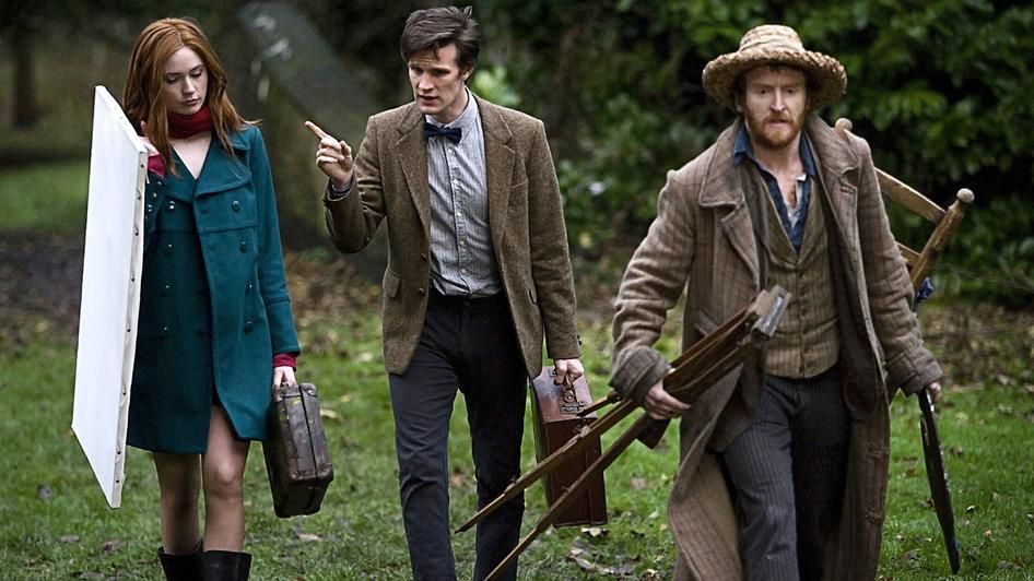 Amy and the Eleventh Doctor help Vincent carry painting supplies in Doctor Who