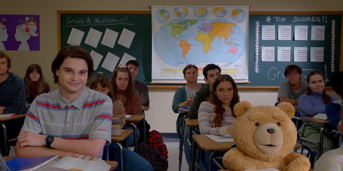 John and Ted sitting at desks in a classroom in a scene from the Peacock series ted.