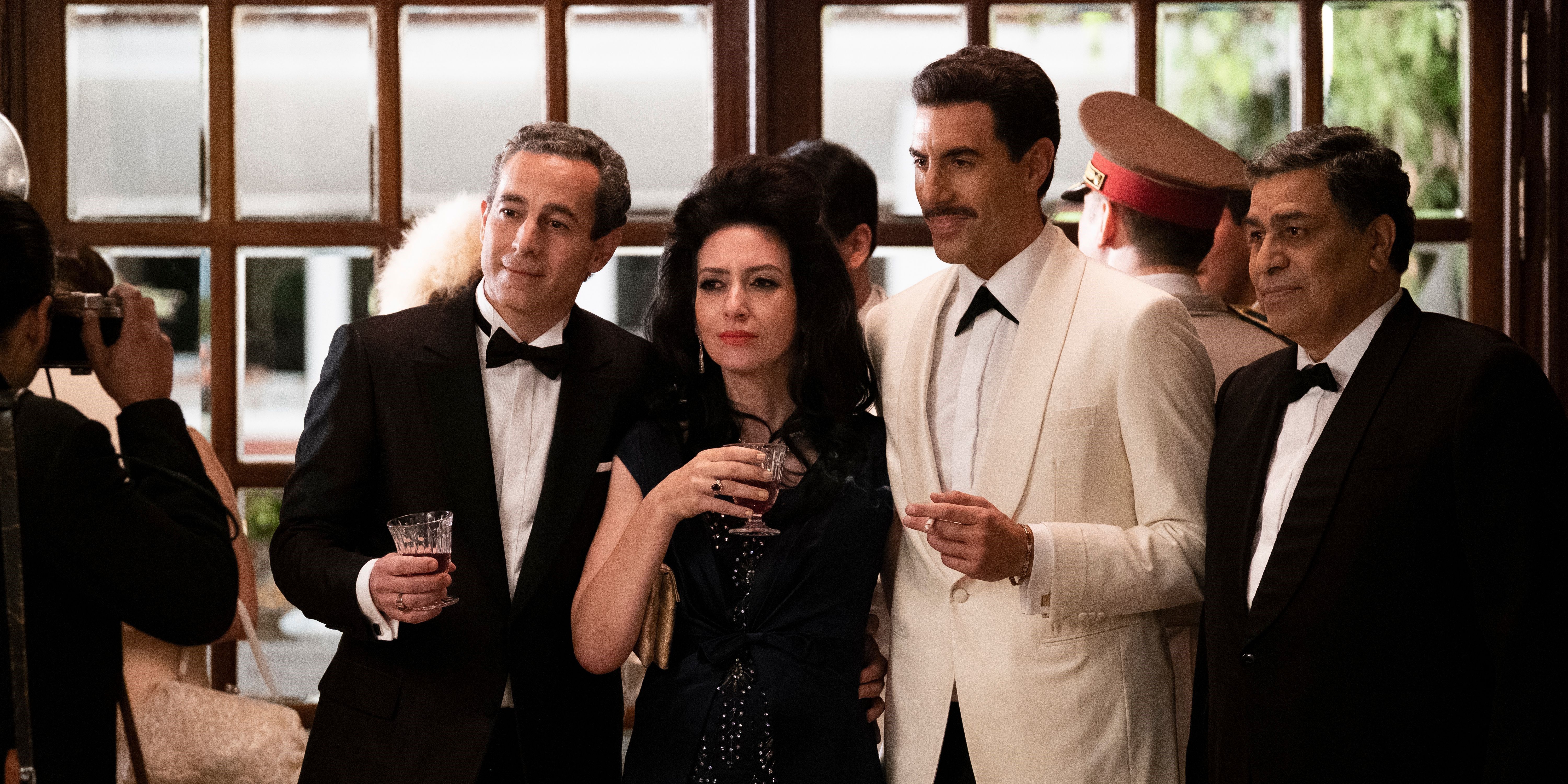 Sasha Baron Cohen takes a picture with a group of people in The Spy