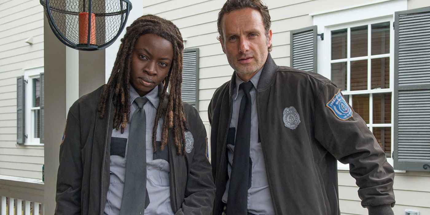 Michonne and Rick Grimes are in police uniforms at Alexandria on The Walking Dead