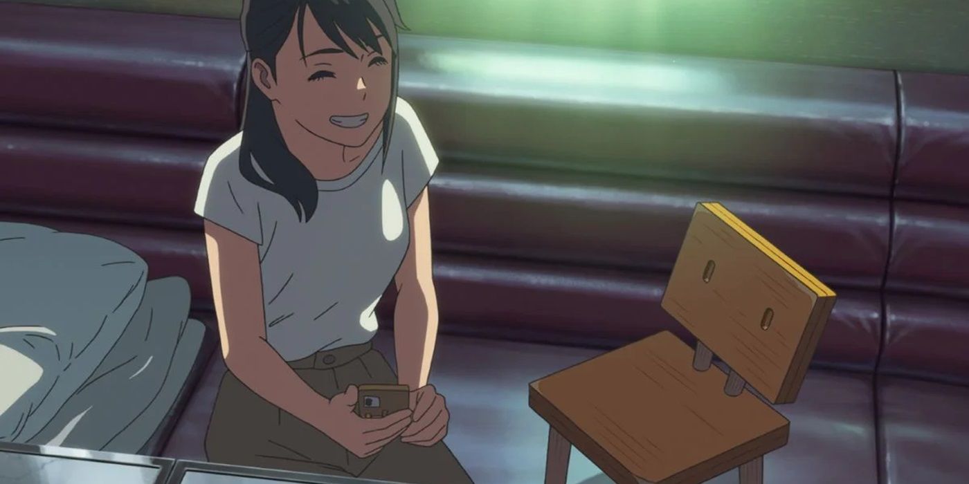 Suzume grinning at Souta in chair form in Makoto Shinkai's titular anime movie.
