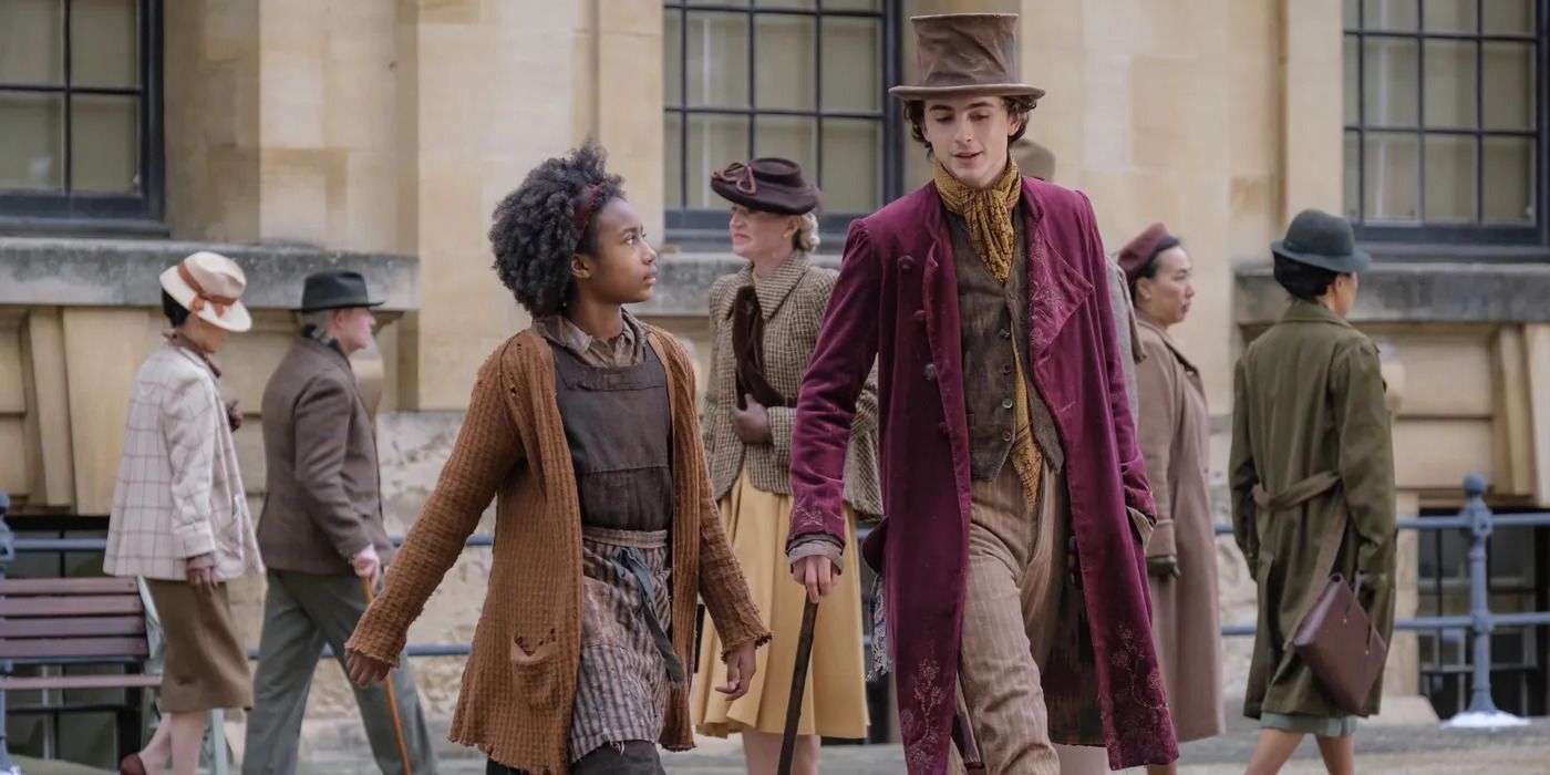 Willy (Timothee Chalamet) and Noodle (Calah Lane) walk through the street in 2023's Wonka