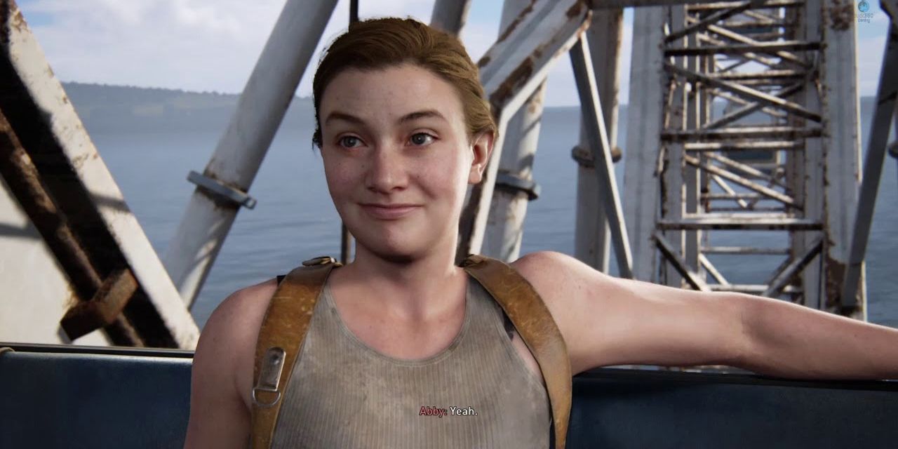 A young Abby nervously smiles while on a ferris wheel in The Last of Us Part II