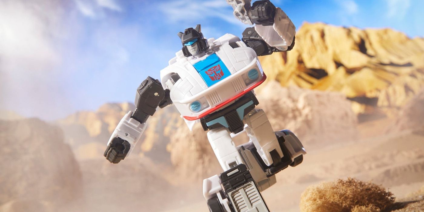A Transformers toy posed to look like it's running through a desert