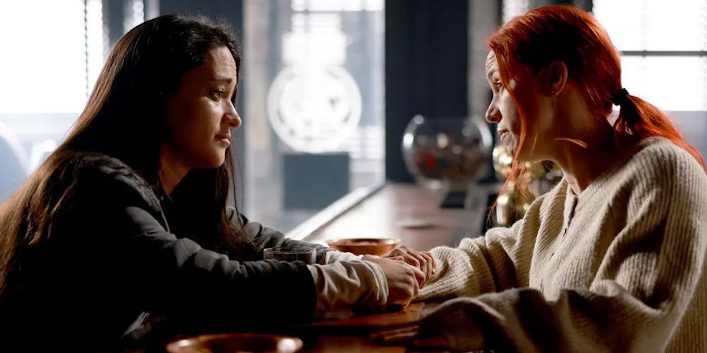 Asta and D'Arcy talk in the bar in Resident Alien