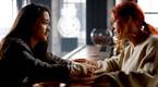 Asta and D'Arcy talk in the bar in Resident Alien