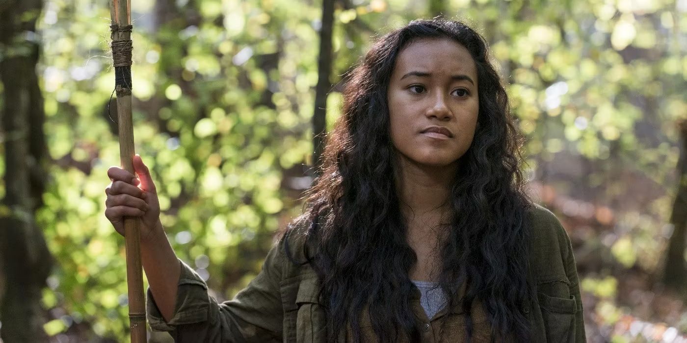 Cyndie (Sydney Park) holds a wooden spear in the Walking Dead