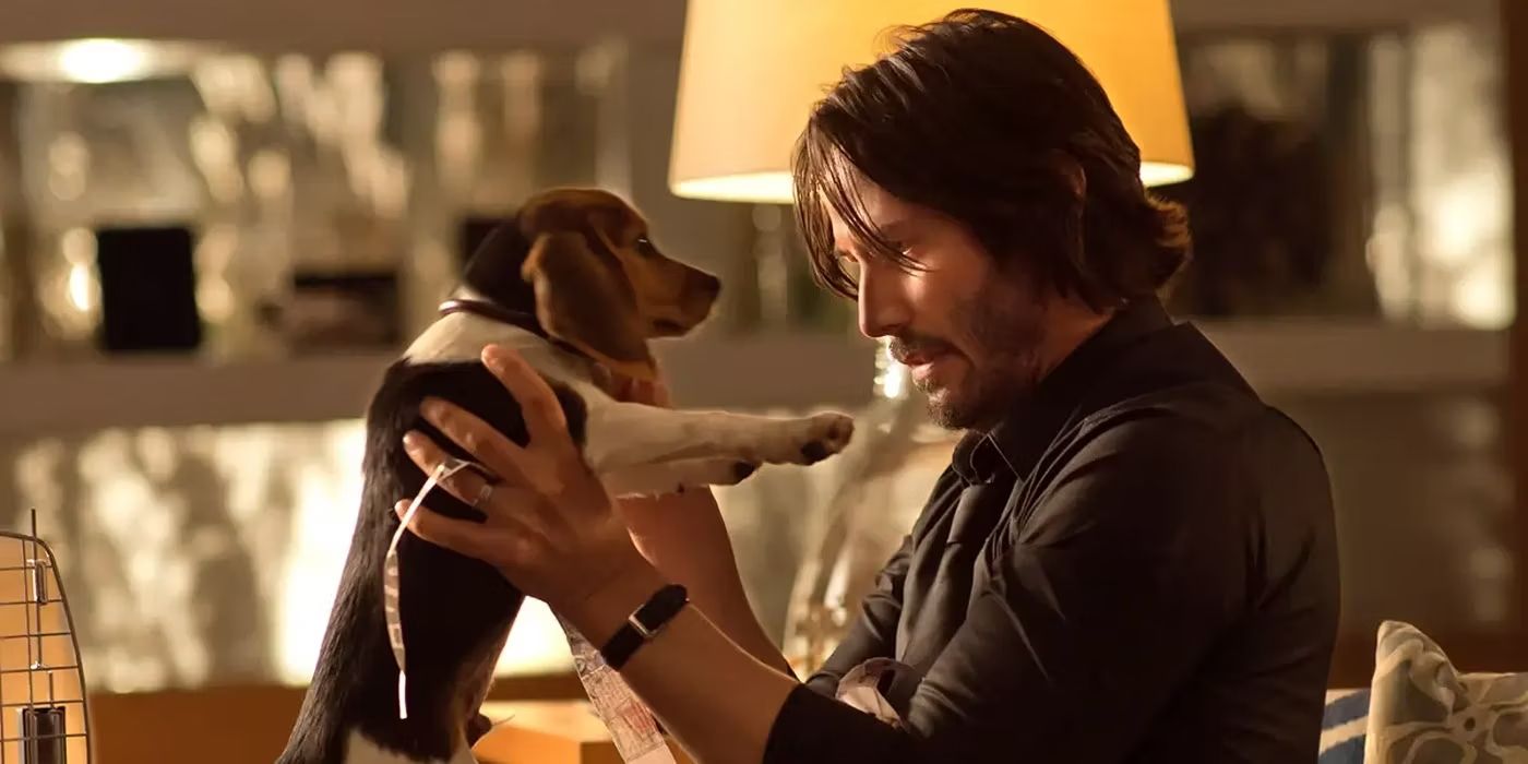 John Wick (Keanu Reeves) holding a puppy in the first John Wick movie