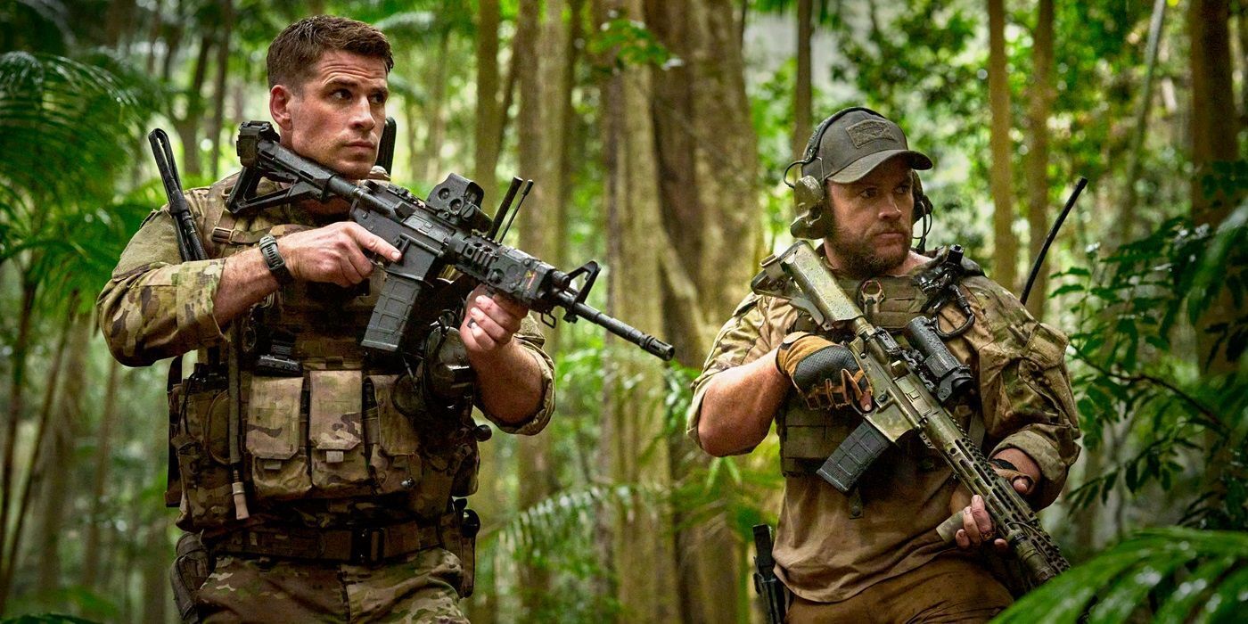 Kinney and Abel (Liam and Luke Hemsworth) hold rifles in the jungle in Land of Bad