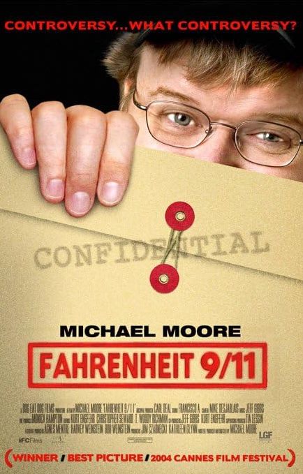 Michael Moore holding an envelope marked Confidential for Fahrenheit 9 11