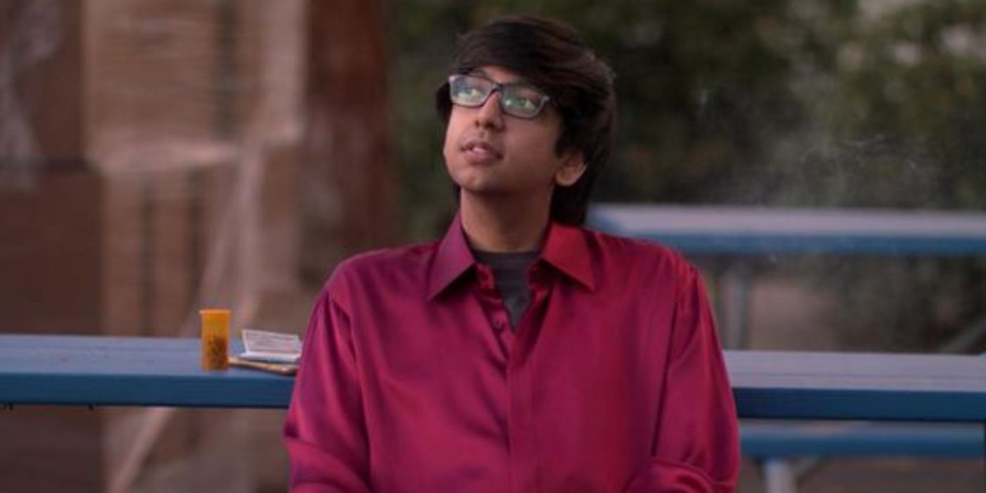 Nik Dodani as Zahid in Atypical sitting on a bench