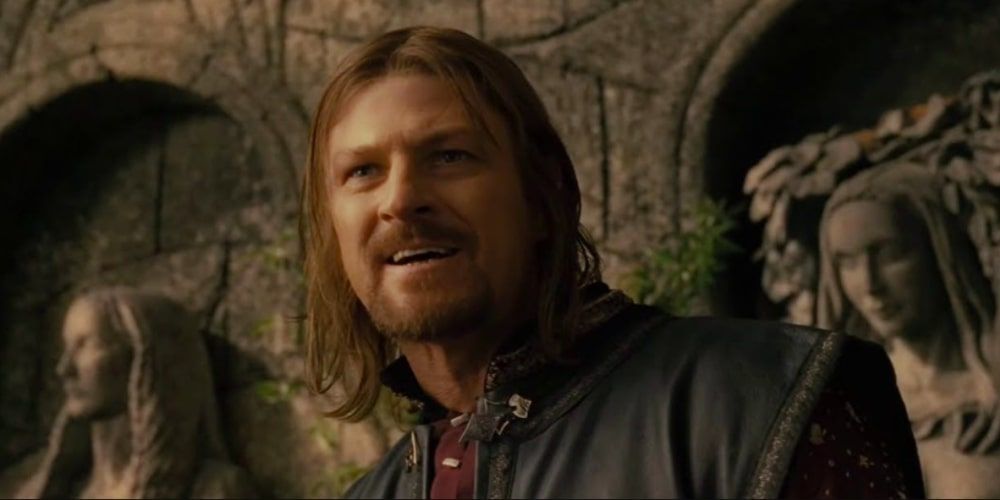 Sean Bean's Boromir smiles while stood by some statues