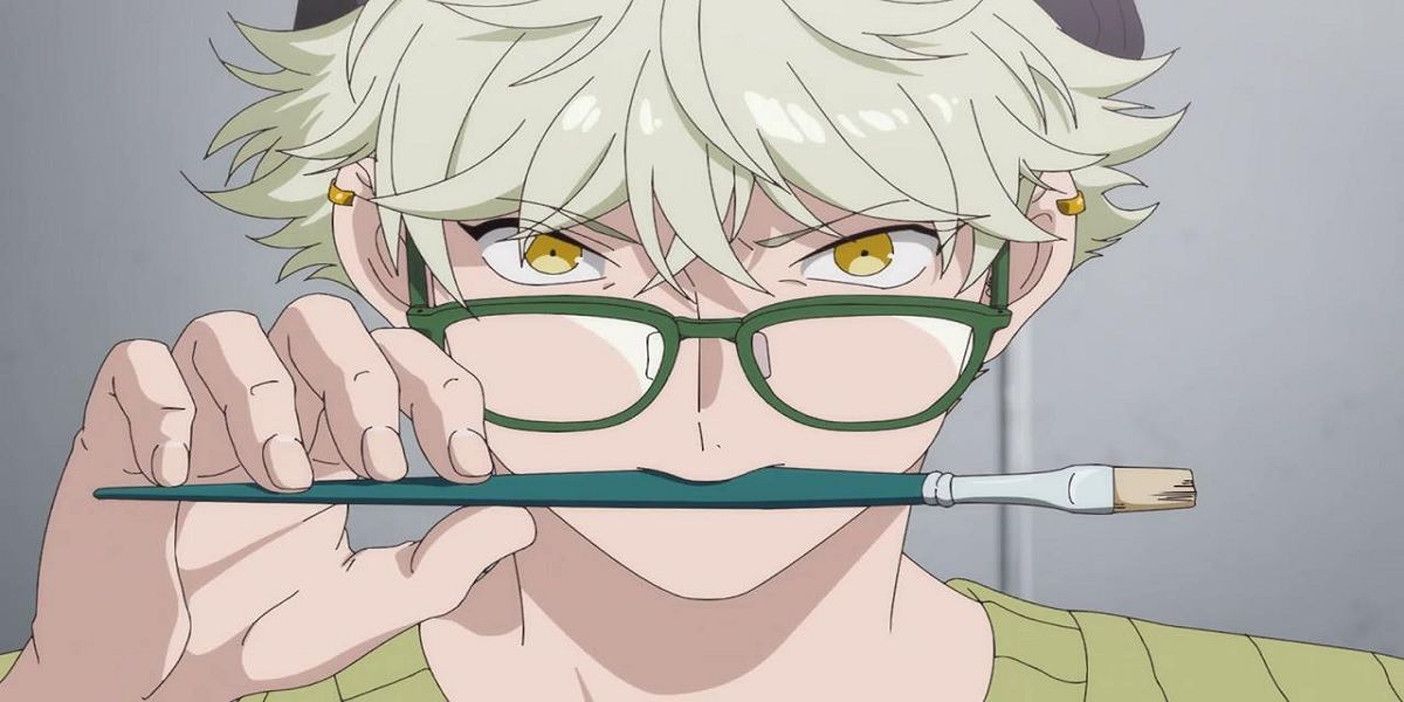 Yatora Yaguchi wears glasses while holding a paintbrush in his mouth