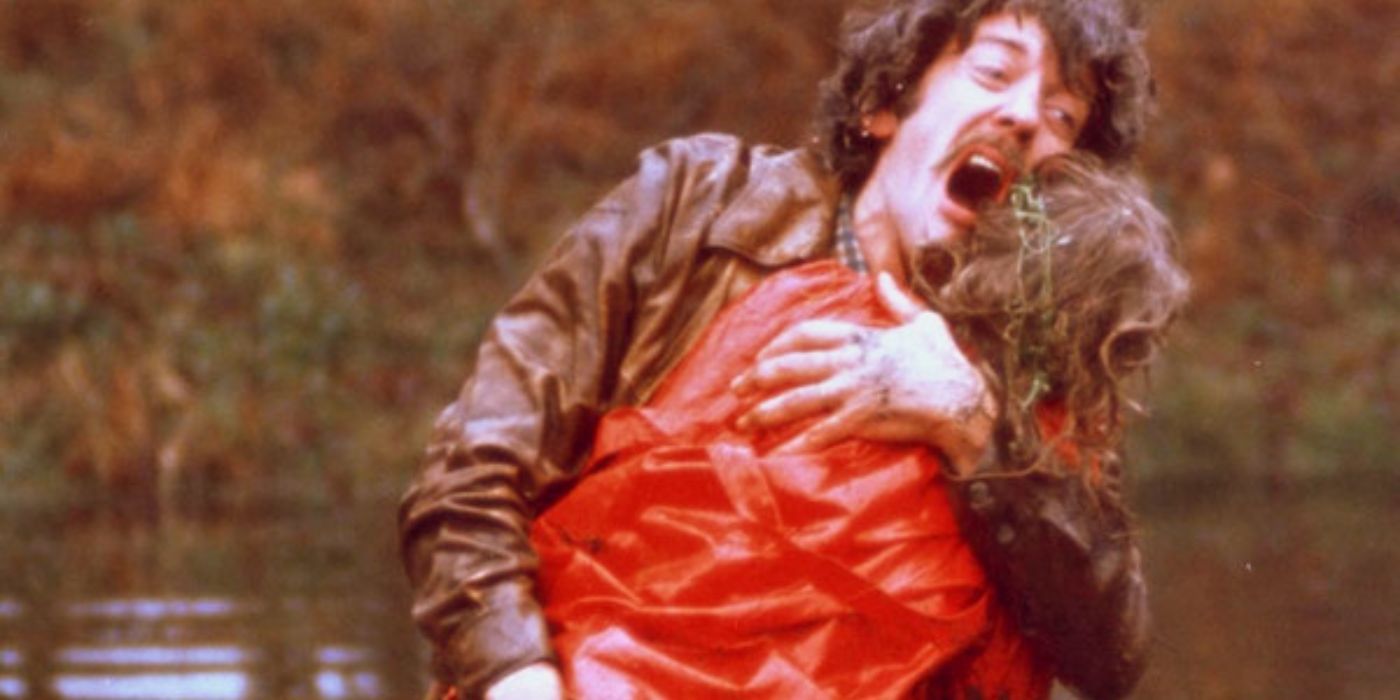 A father holds his deceased daughter tightly in his arms