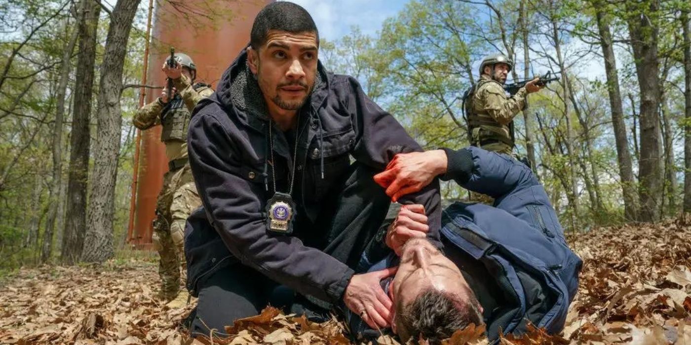 Brent Antonello as Jamie Whelan lies on the ground as Rick Gonzalez as Bobby Reyes tries to stop the bleeding on his neck on Law & Order_ Organized Crime