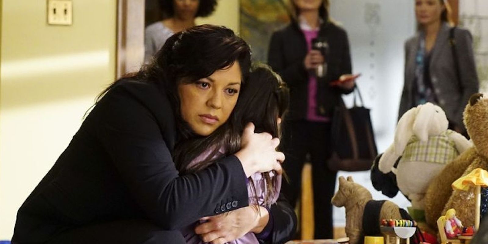 Callie looking sad and hugging Sofia tightly in Grey's Anatomy