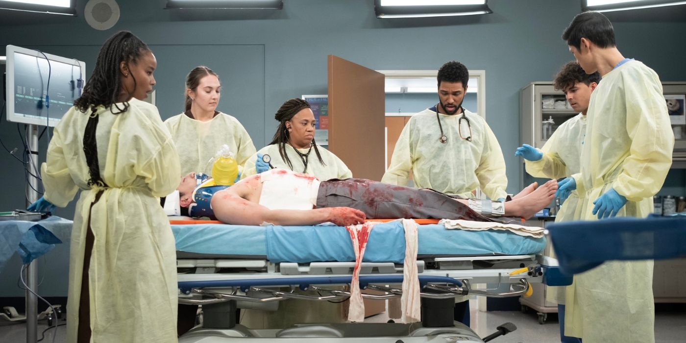 Chandra Wilson as Miranda Bailey (middle) stands with Anthony Hill as Winston Ndugu, Niko Terho as Lucas Adams, and Harry Shum Jr. as Benson Kwan in a trauma room on Grey's Anatomy