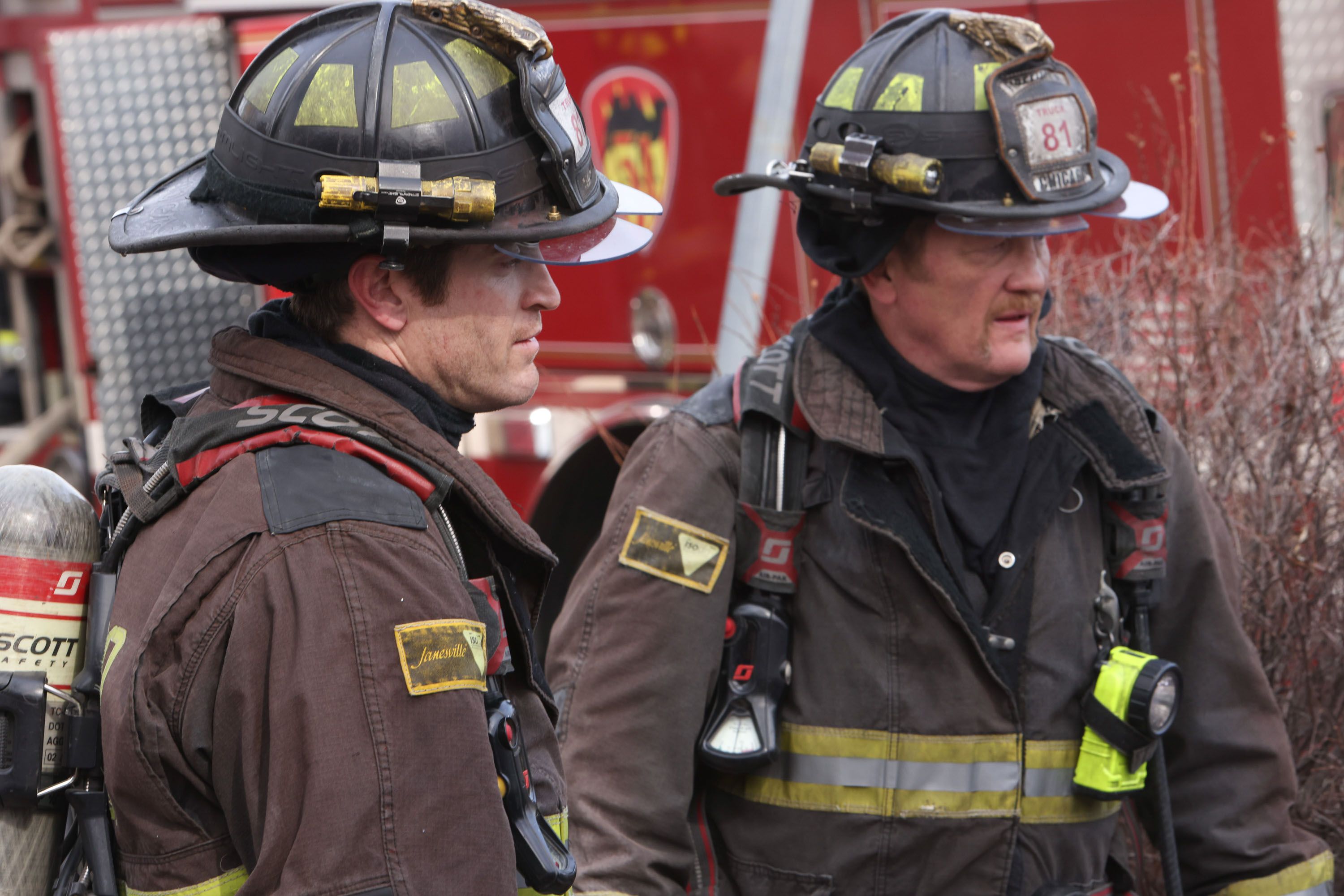 Mouch and Carver in uniform standing by the fire truck in Chicago Fire Season 12, Episode 7