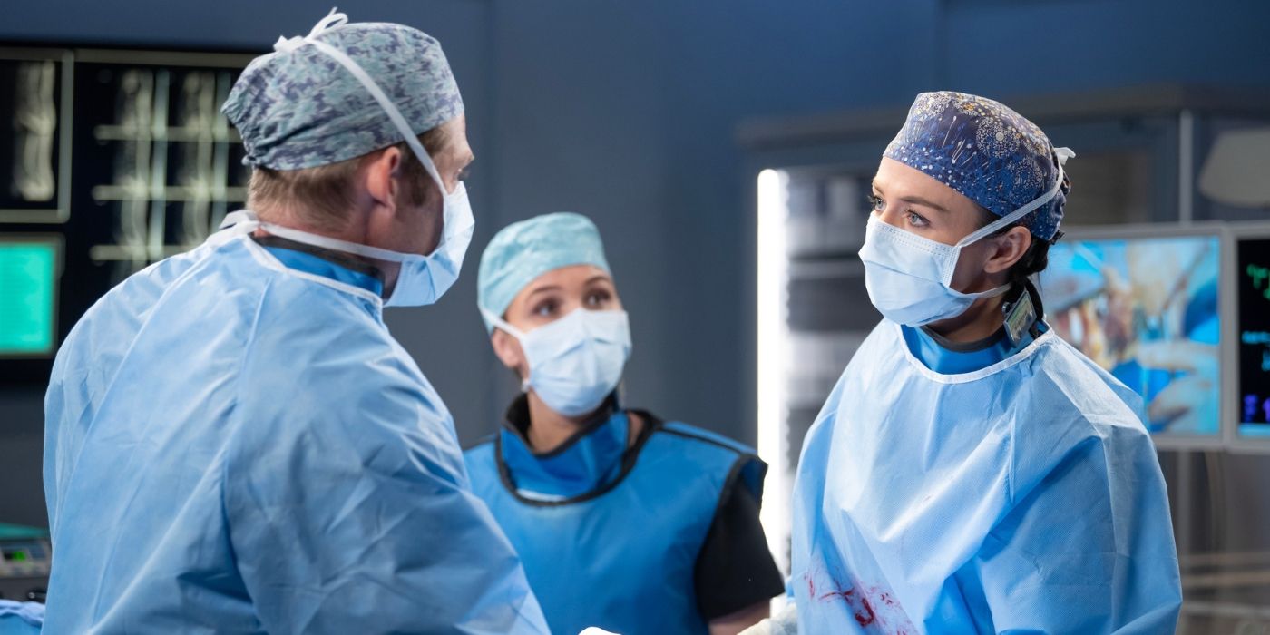 Chris Carmack as Atticus _Link_ Lincoln, Camila Luddington as Jo Wilson, and Caterina Scorsone as Amelia Shepherd operate on a patient on Grey's Anatomy