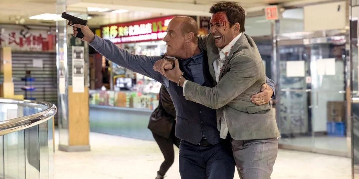 Christopher Meloni as Elliot Stabler helps a hurt Dylan McDermott as Richard Wheatley out of a mall on Law & Order_ Organized Crime