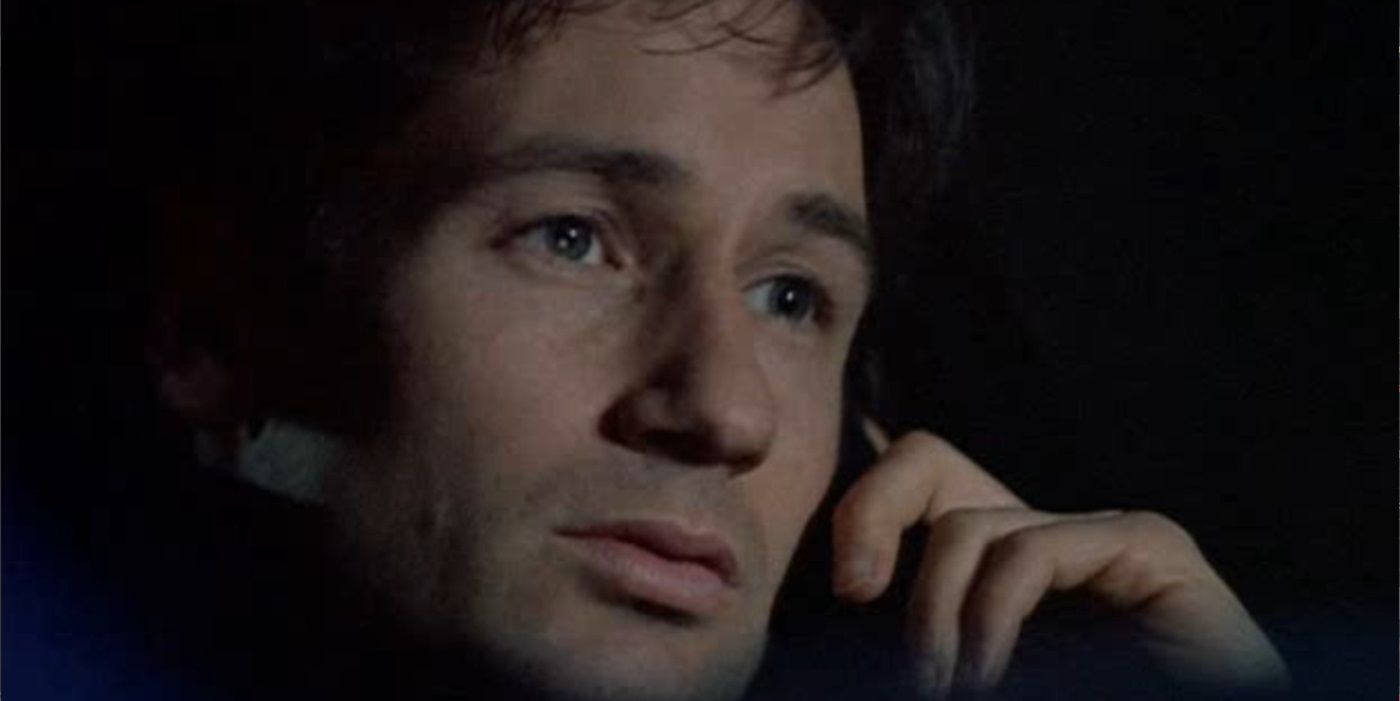 Close up of Mulder's face as he's on the phone in a car from The X-Files