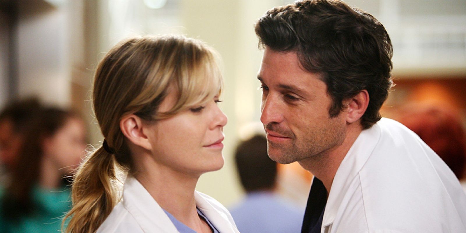 Derek leaning in to kiss a skeptical Meredith in Grey's Anatomy.