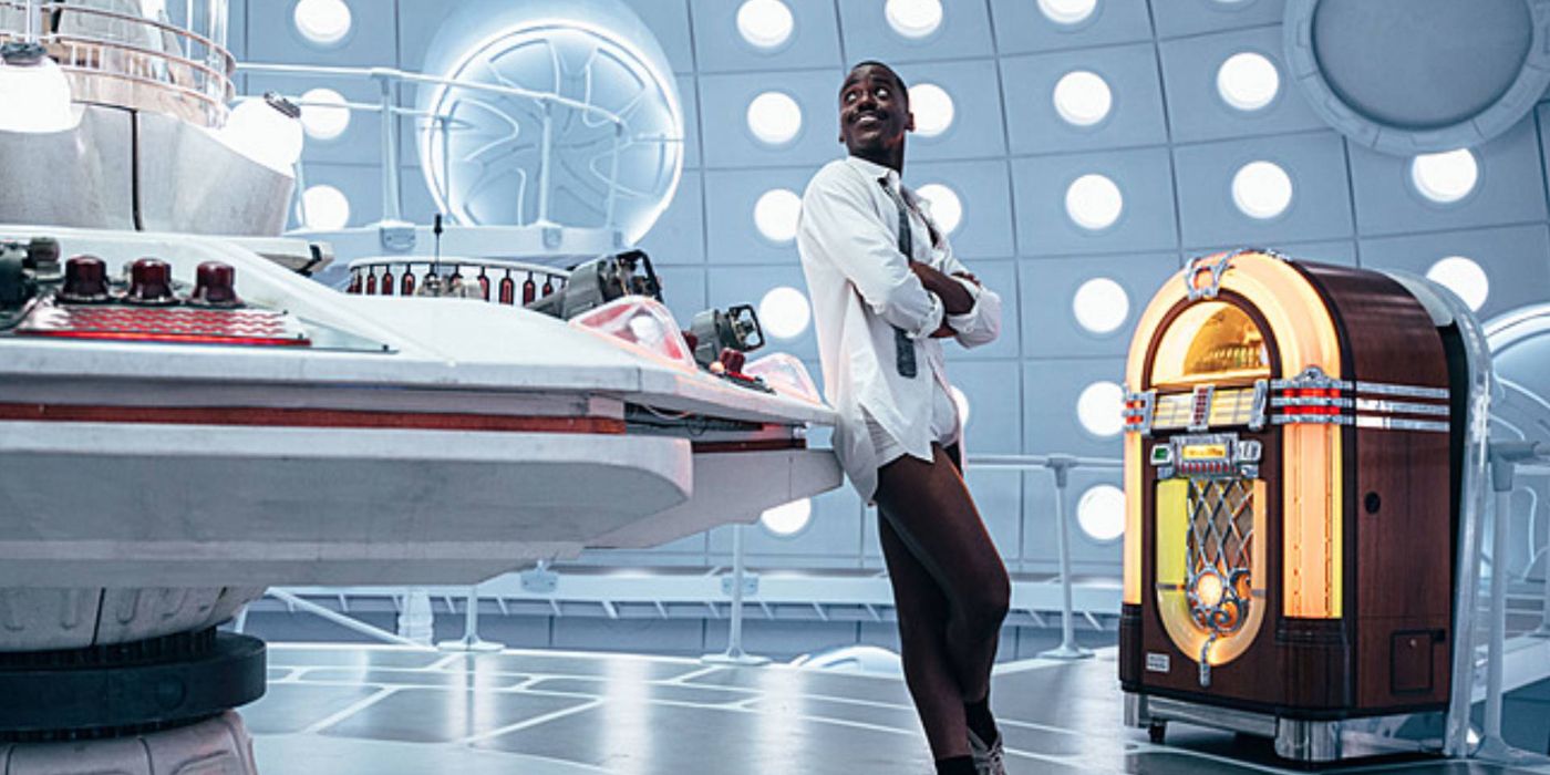 Ncuti Gatwa as the Fifteenth Doctor in the TARDIS, beside his jukebox, on Doctor Who.