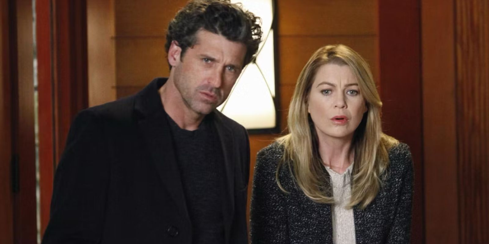 Derek and Meredith stand in the doorway looking shocked and confused in Grey's Anatomy.