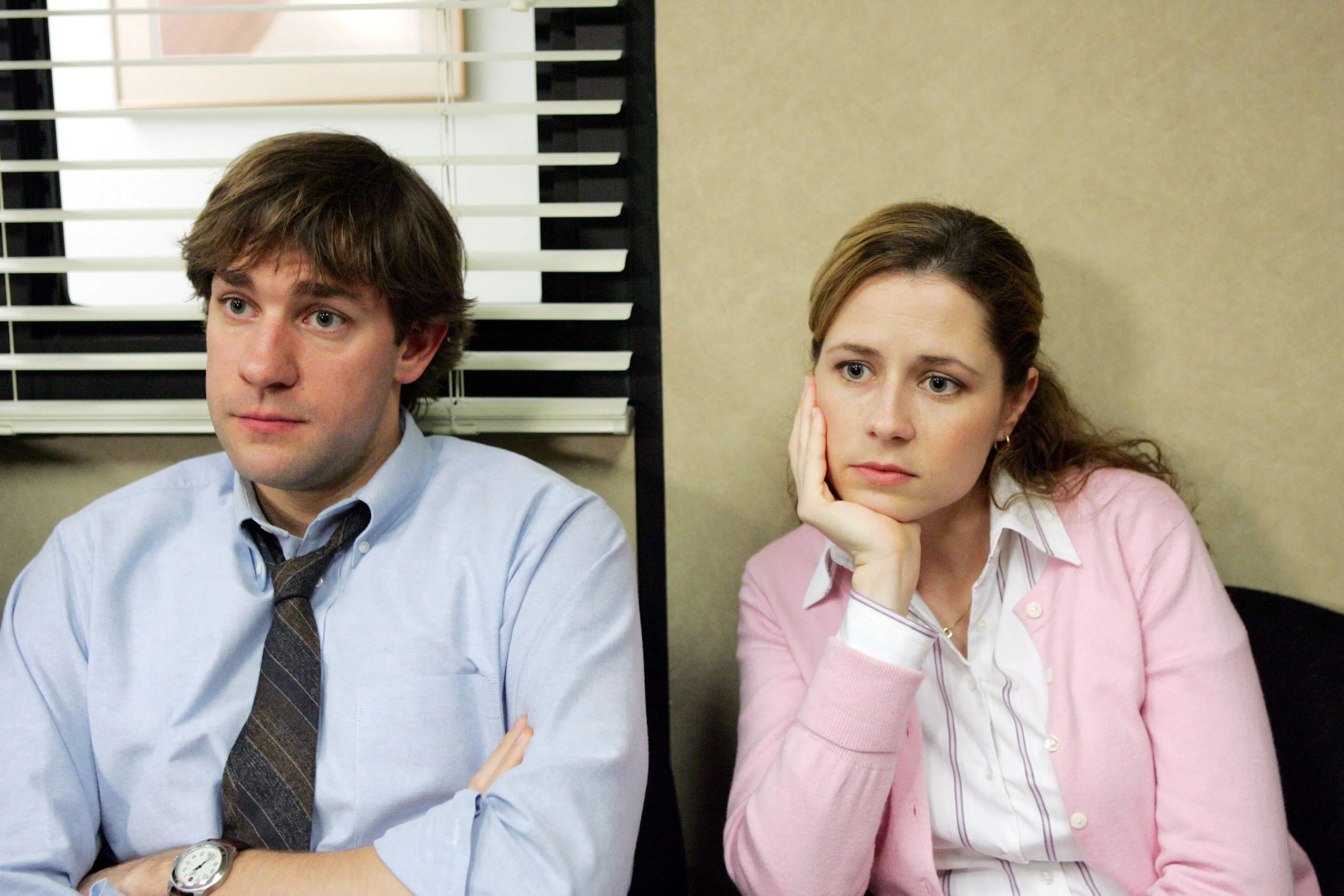 Jim and Pam look bored yet alarmed in the Office