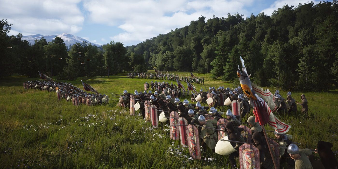 A medieval army from Manor Lords gathers together in front of a forest.