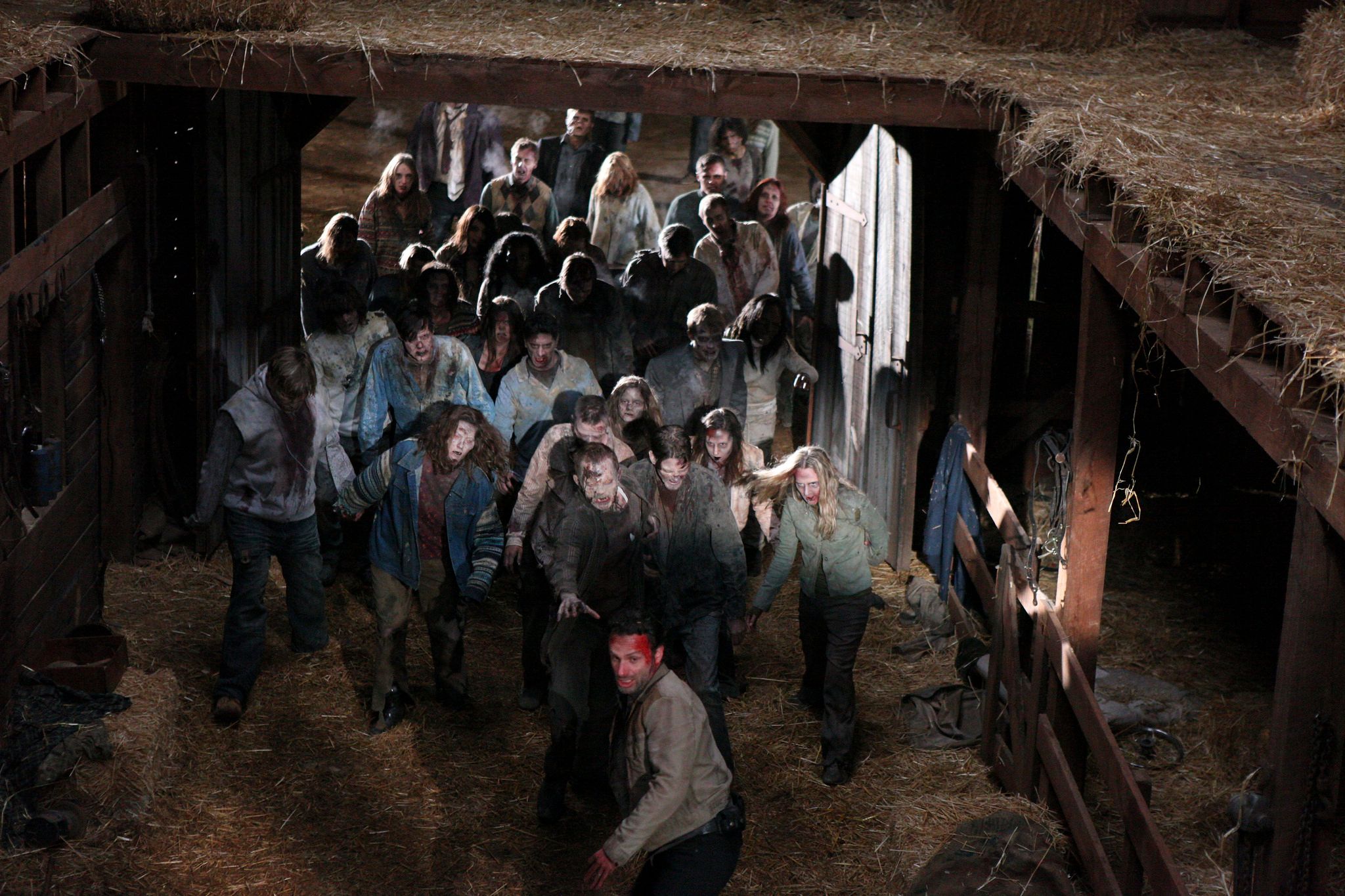 Rick leading a pack of zombies in The Walking Dead S2 E13