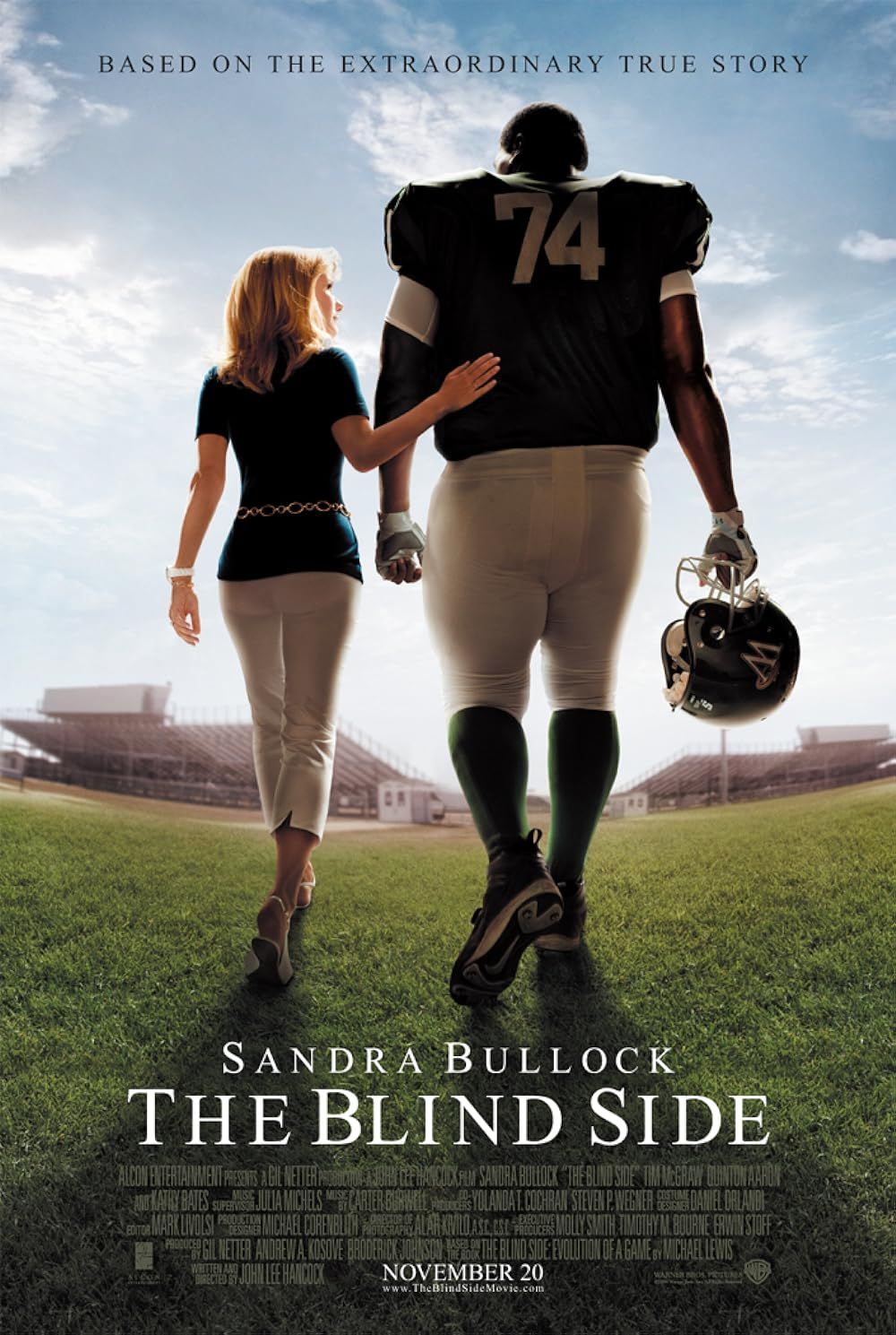Sandra Bullock and Quinton Aaron walk together on the poster for The Blind Side