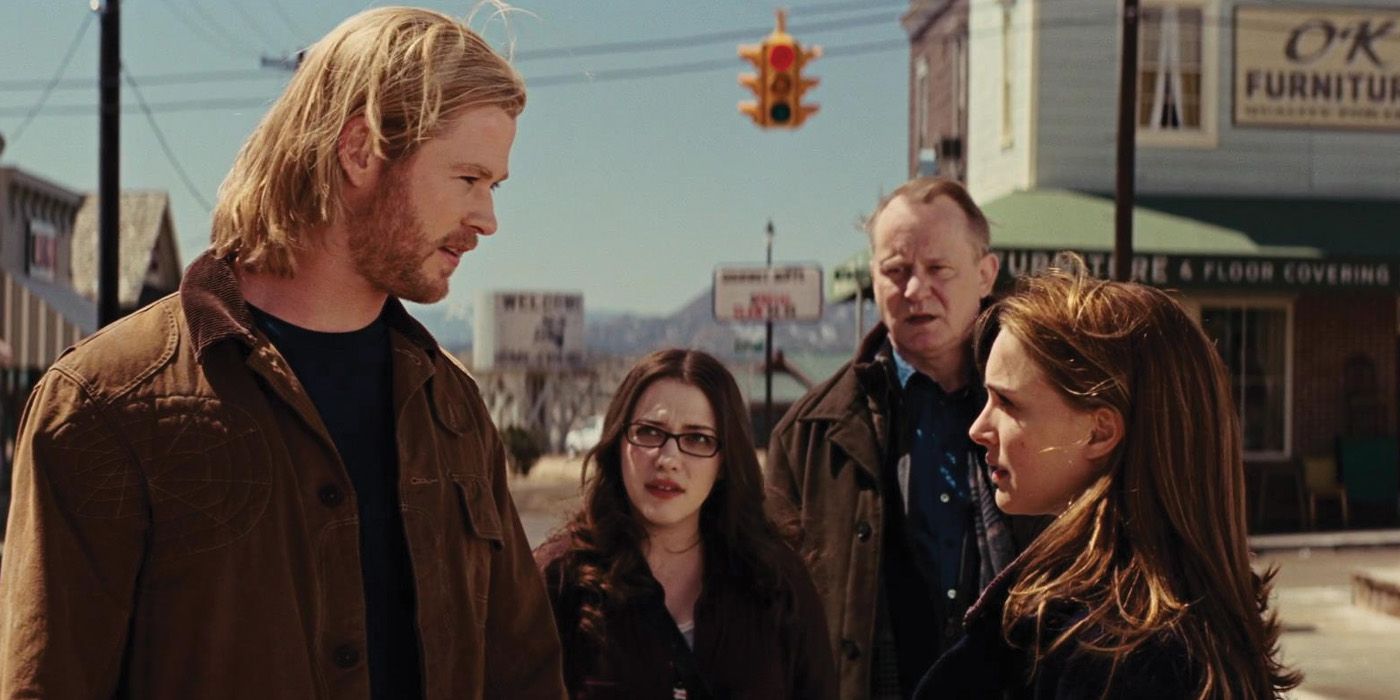 Thor talks to Jane Foster while Darcy and Erik Selvig watch.