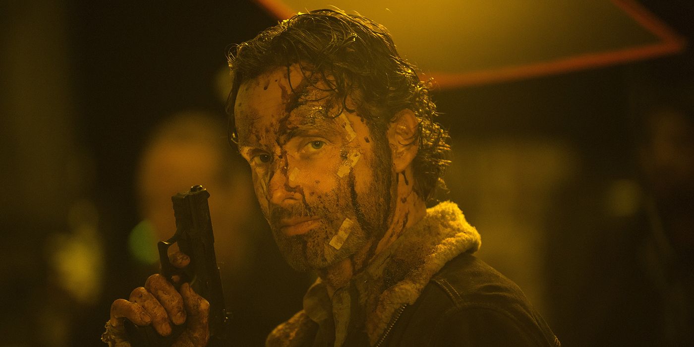 Rick with a bloody face holding a gun in The Walking Dead