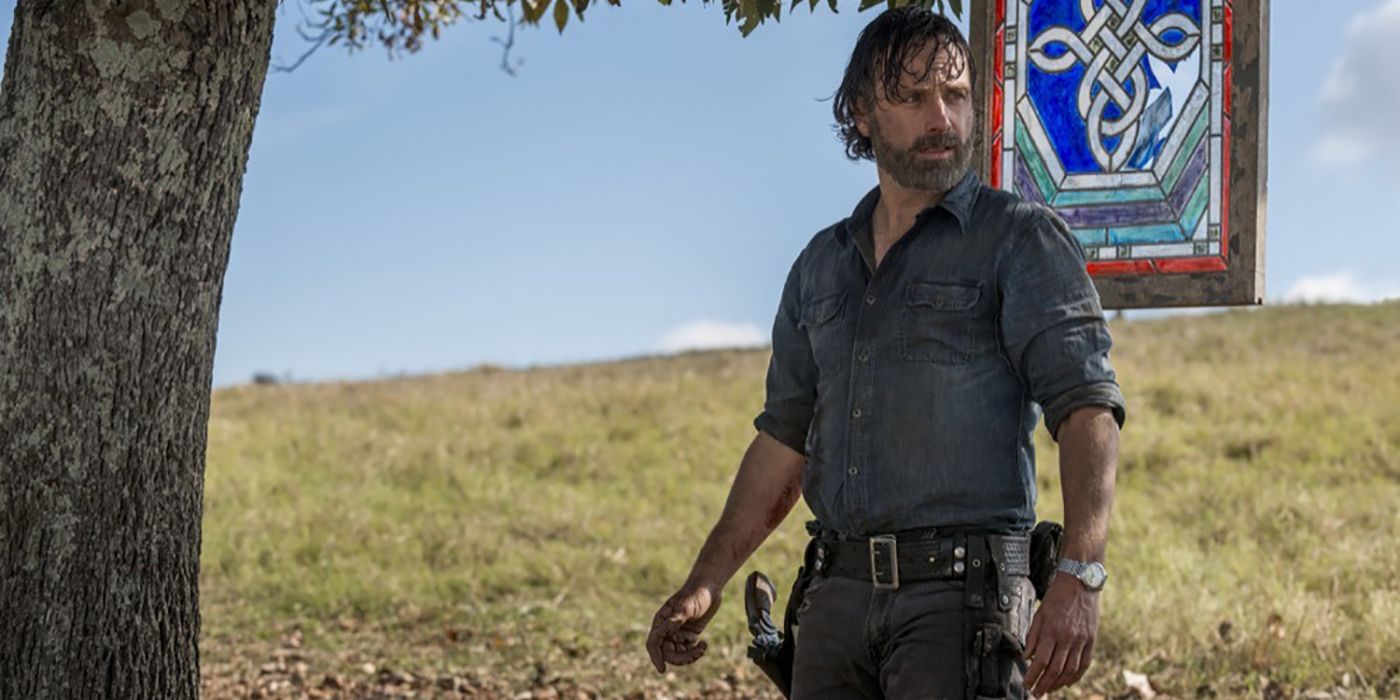 Rick standing by a tree looking disheveled on The Walking Dead