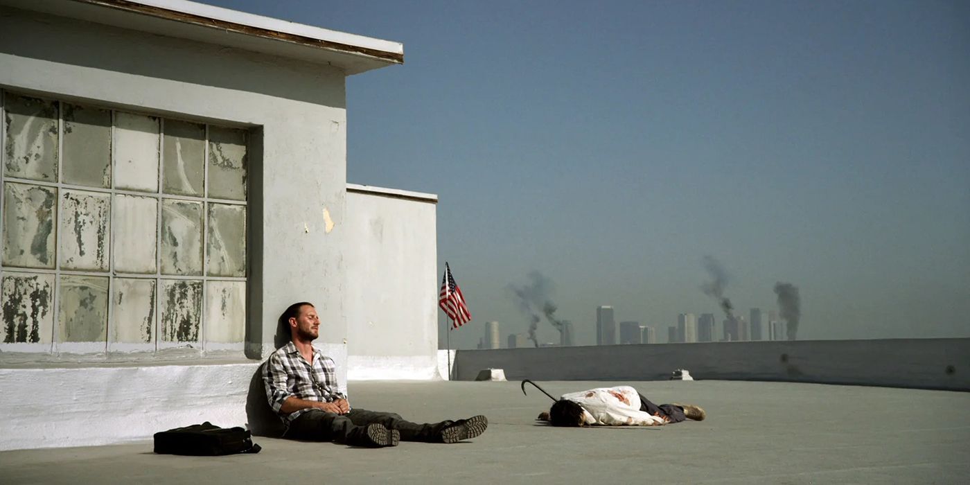 A man sitting on the roof of a building looking dejected in The Walking Dead webisodes.