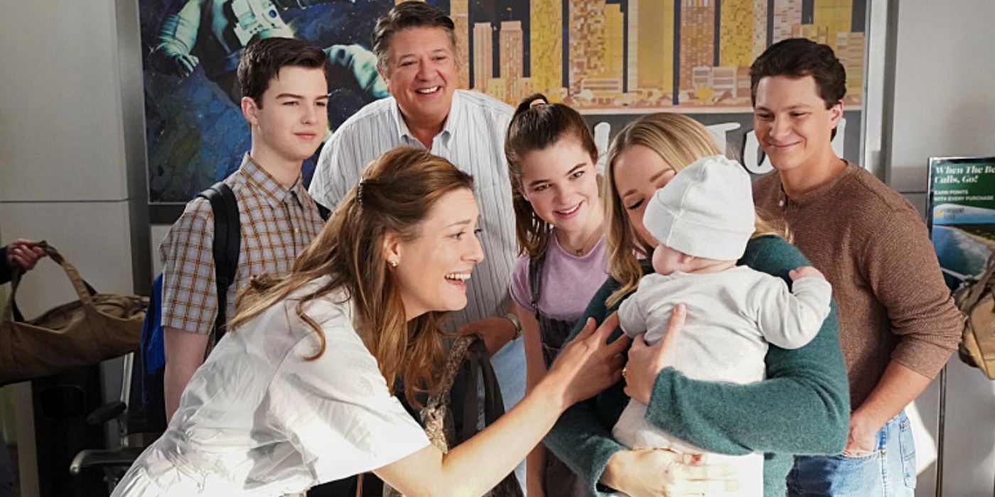 The Cooper family looking at baby CeCe Cooper at the airport on Young Sheldon