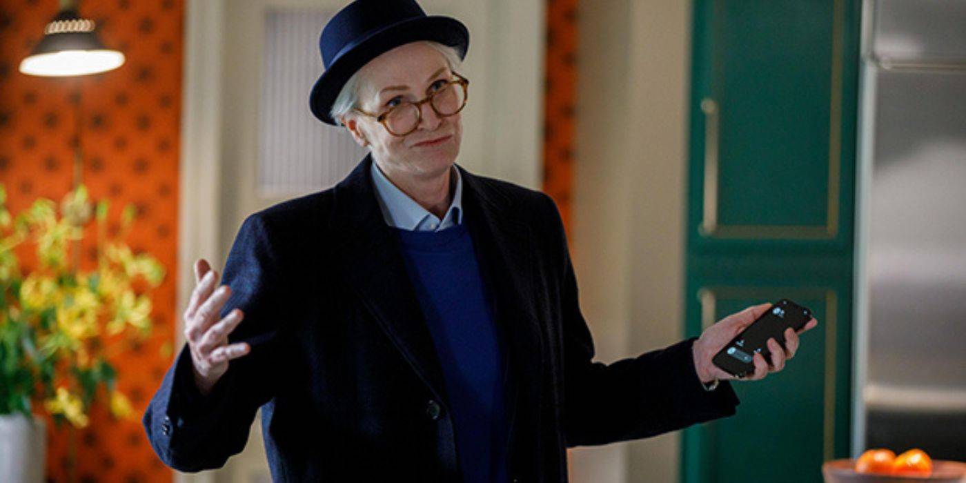 Sazz Pataki shrugging her shoulders and holding up a phone in Only Murders in the Building.