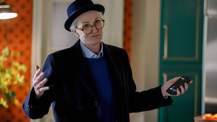 Sazz Pataki shrugging her shoulders and holding up a phone in Only Murders in the Building.