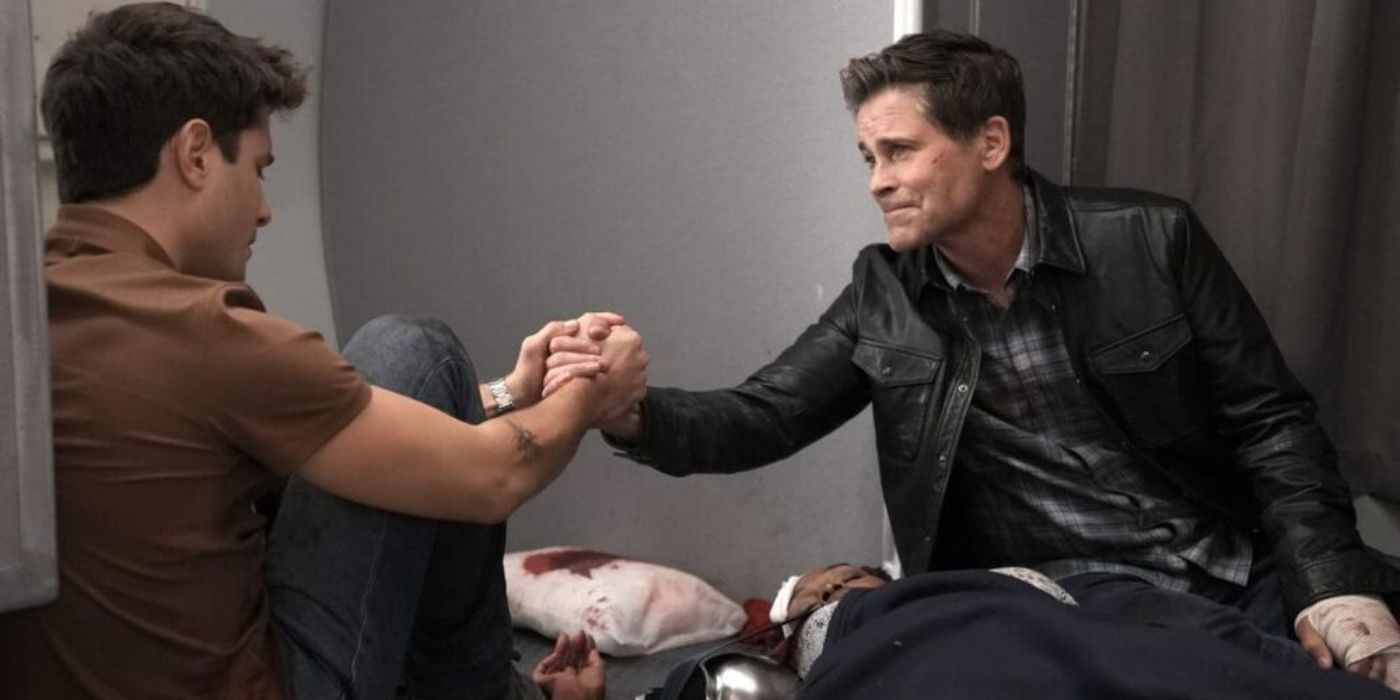 TK Strand (Ronen Rubenstein) and Owen Strand (Rob Lowe) holding hand over a patient in 911 Lone Star episode "In the Unlikely Event of an Emergency"