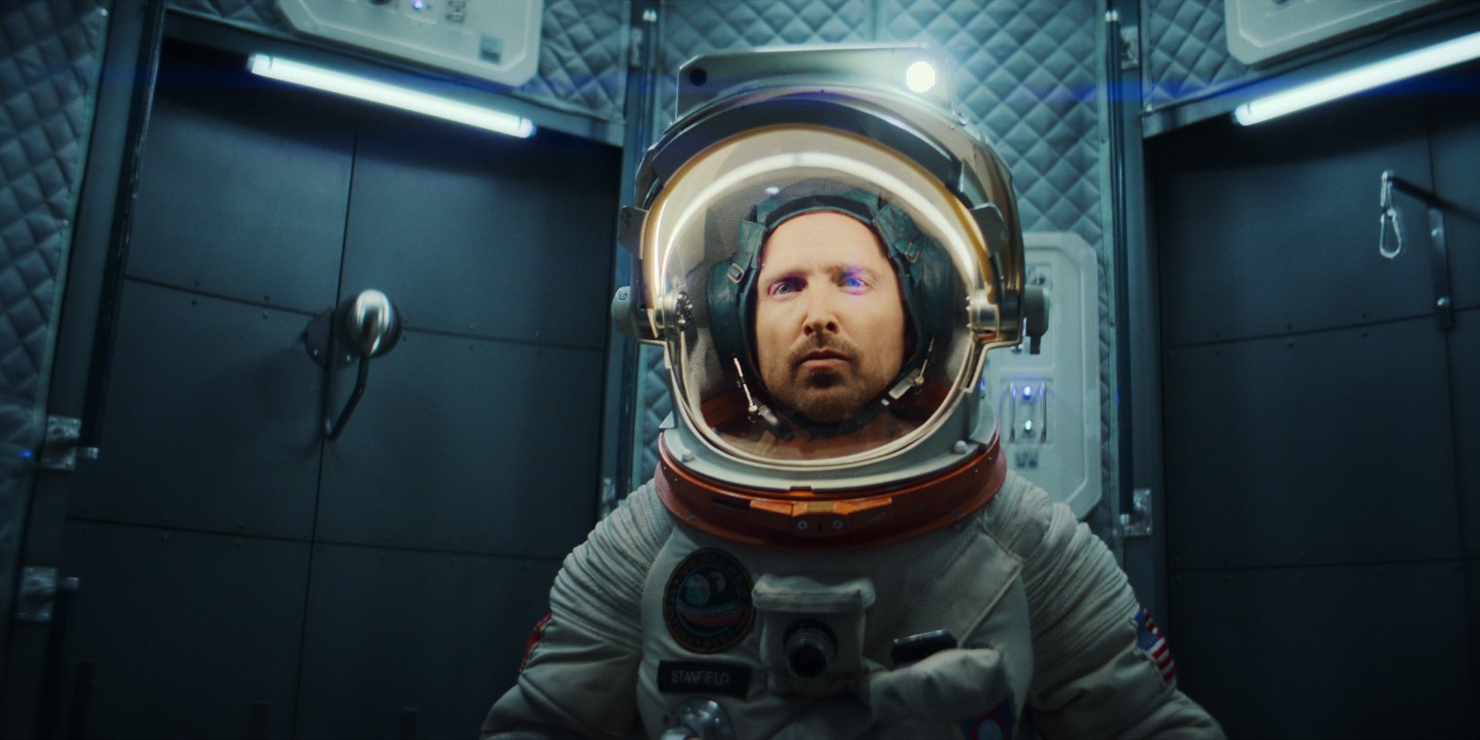 Cliff (actor Aaron Paul) sits in his astronaut spacesuit in Black Mirror Season 6
