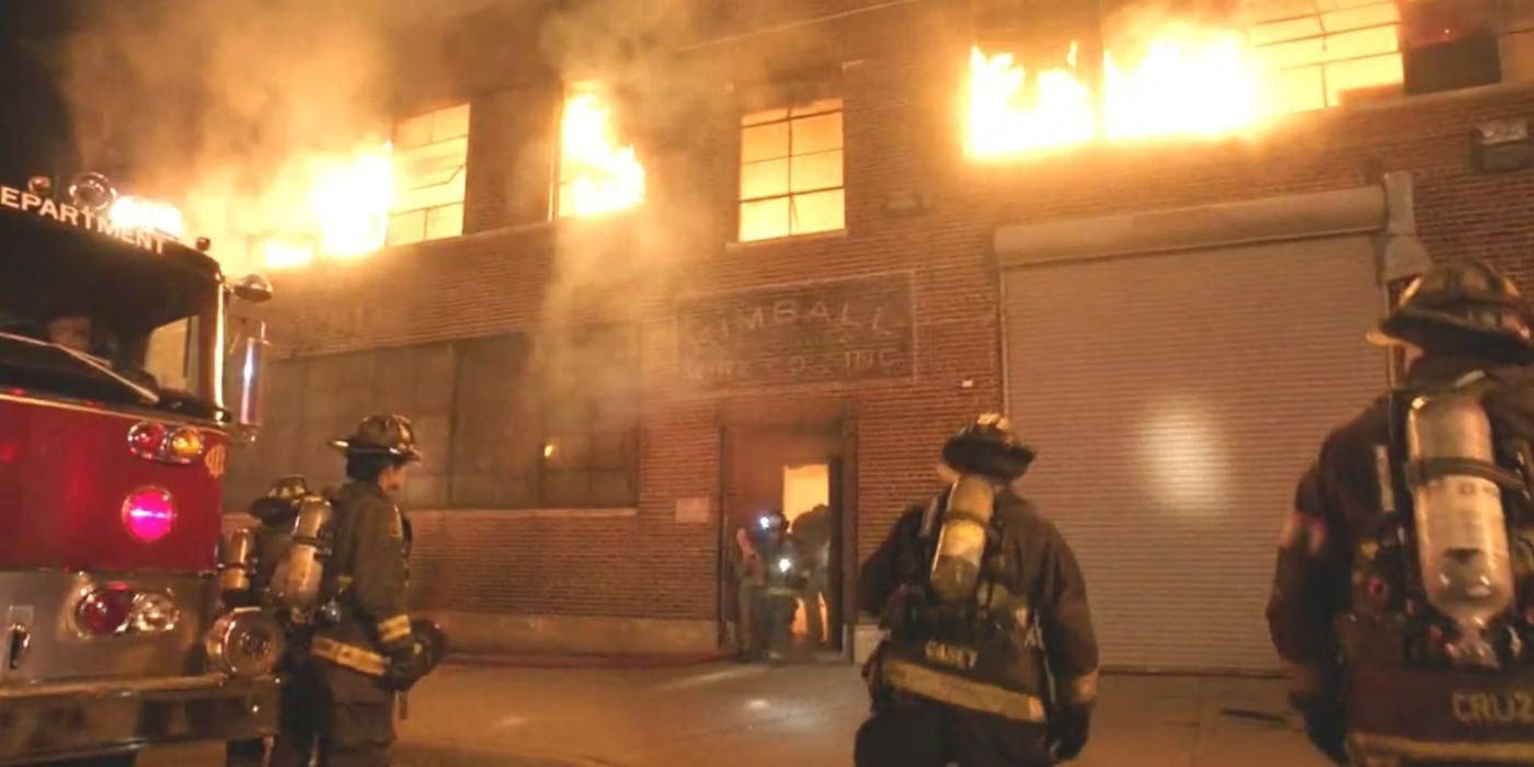 Firefighters standing outside of a burning building in Chicago Fire episode "Deathtrap"