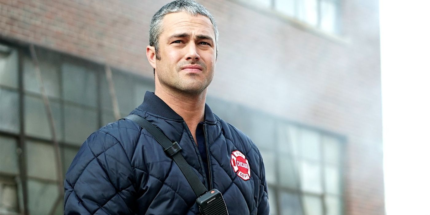 Taylor Kinney as Kelly Severide standing outside of a building in Chicago Fire episode "Deathtrap"