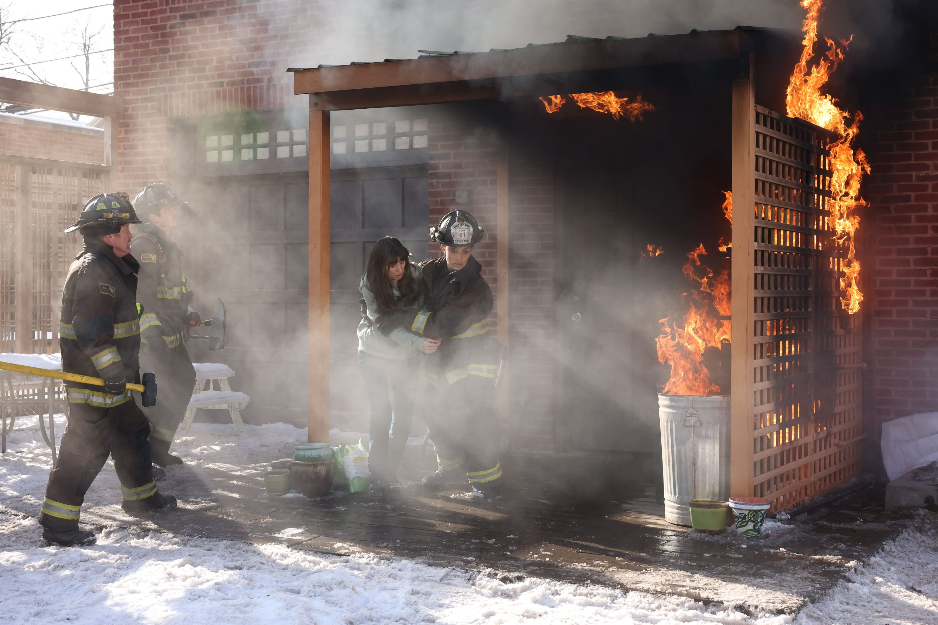 A backyard fire burns a patio structure while firefighters battle it on Chicago Fire