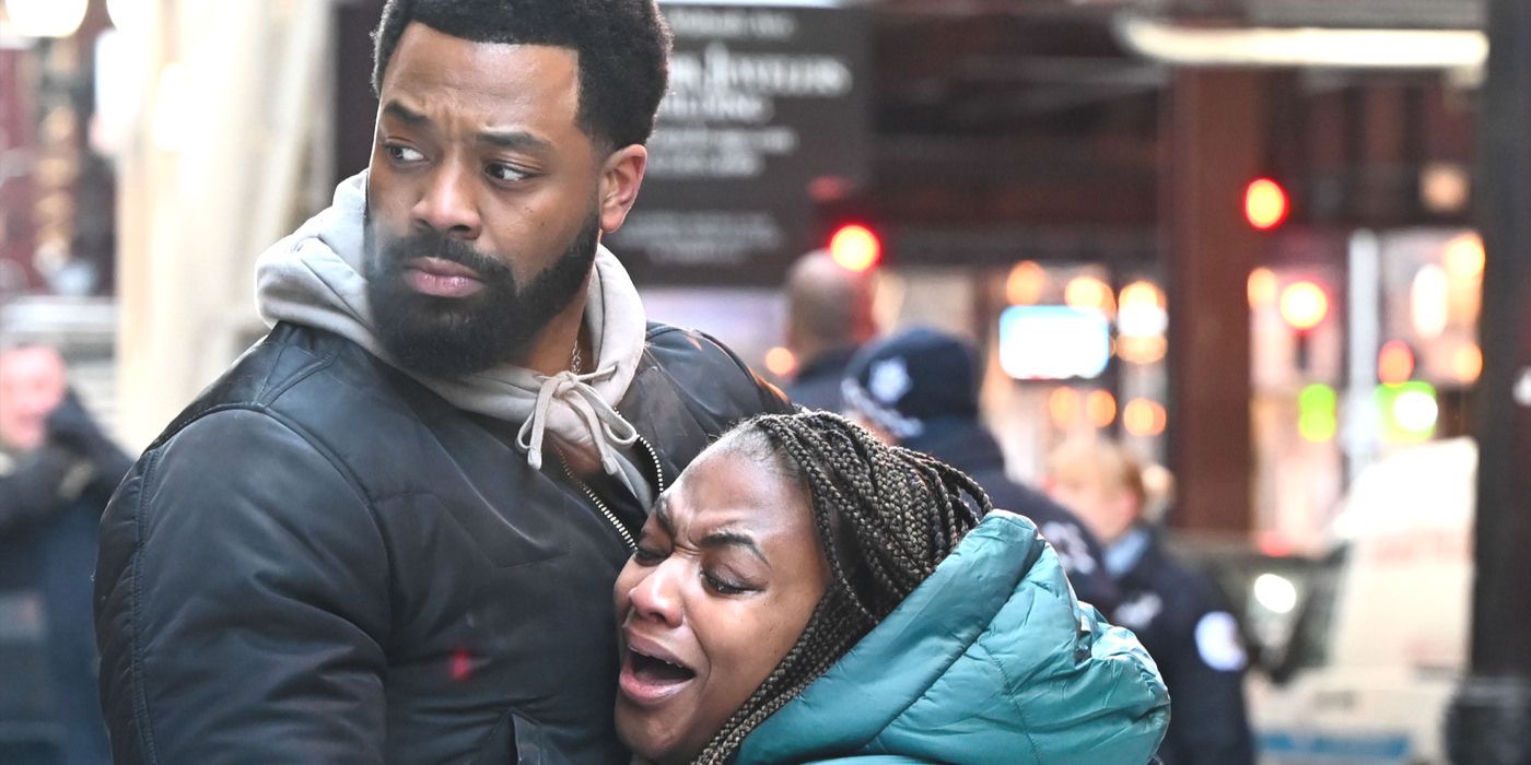Kevin Atwater (actor LaRoyce Hawkins) looks off while holding a crying victim on Chicago PD