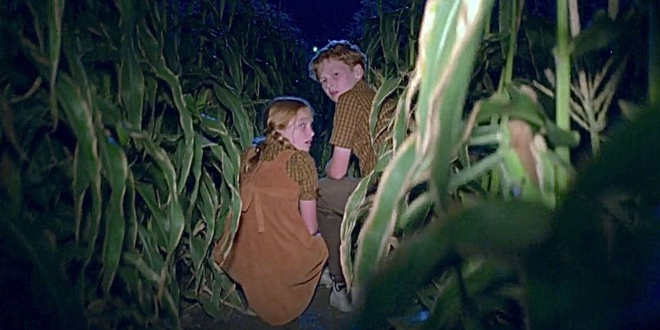 Two children looking at the light behind them in a cornfield in Criminal Minds "Elliott's Pond."