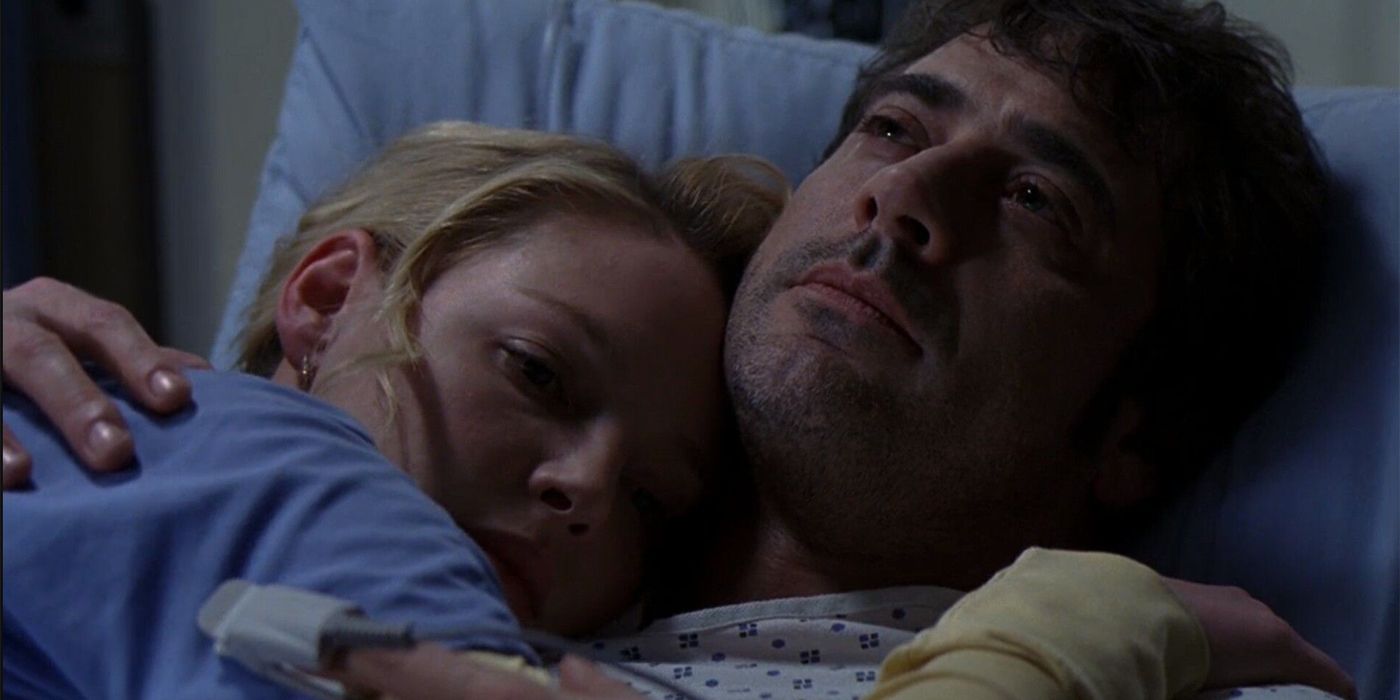 denny and izzie are hugging each other in grey's anatomy.