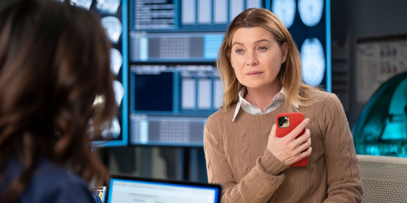 Ellen Pompeo as Meredith Grey sits in front of large display screens on Grey's Anatomy