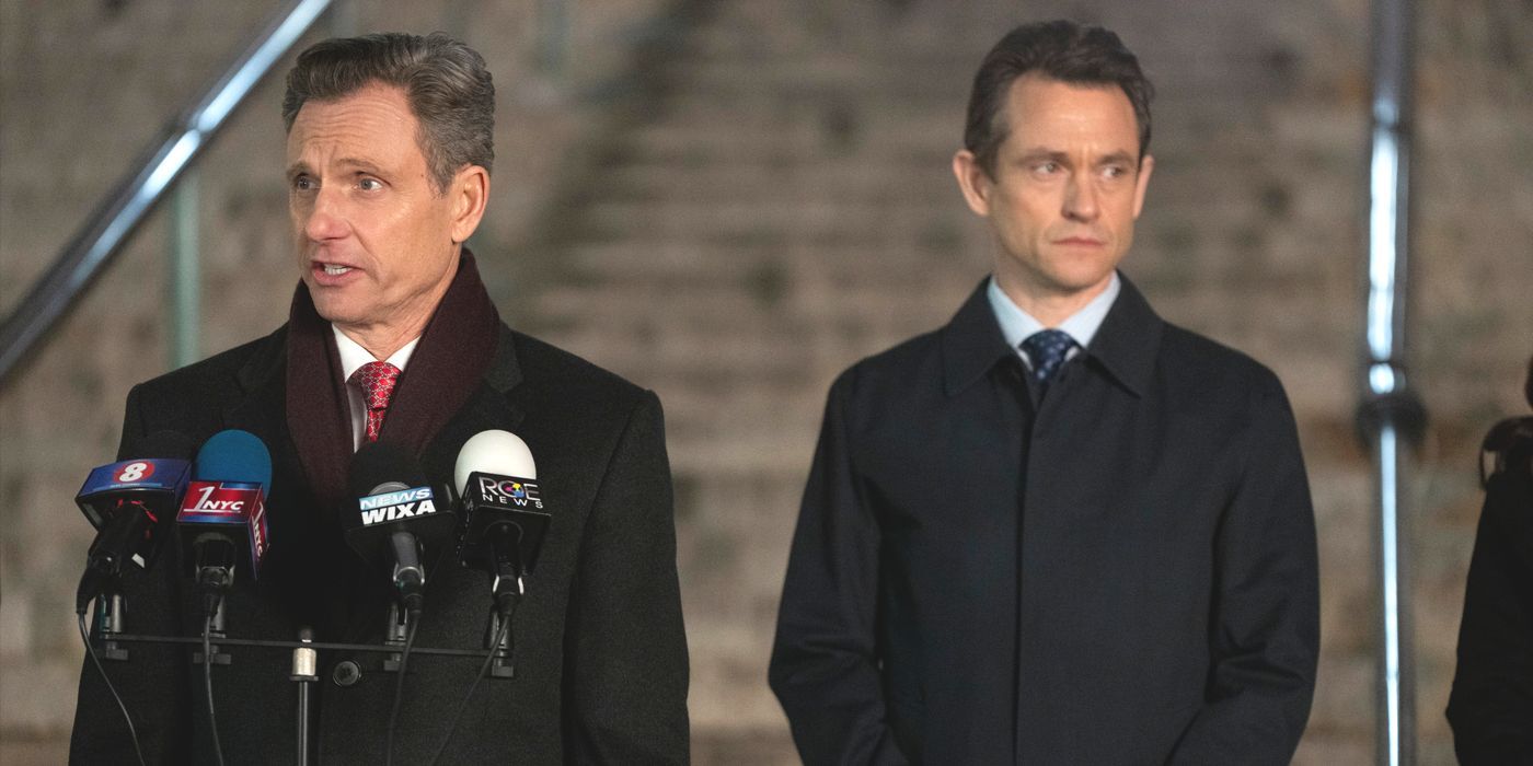 Baxter (actor Tony Goldwyn) and Price (actor Hugh Dancy) stand at press conference in Law & Order