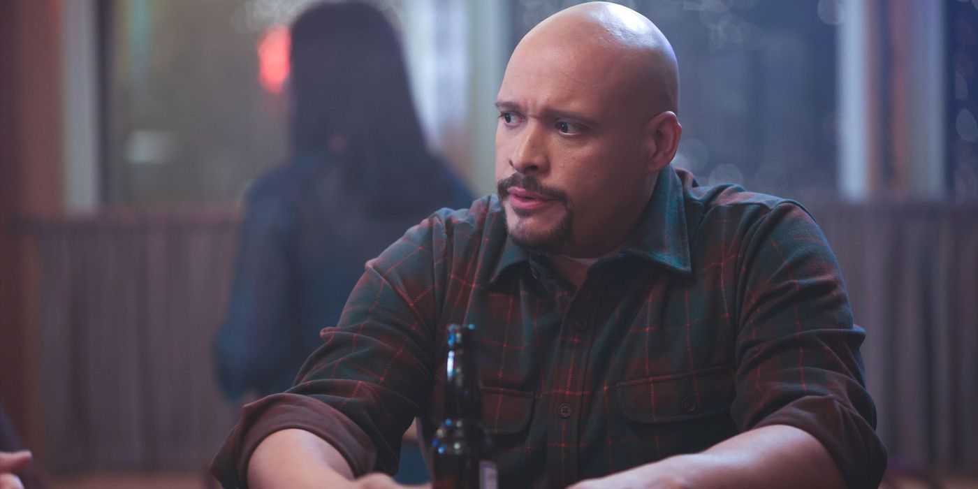 Joe Cruz (Joe Minoso) sits at Molly's bar in a dark plaid shirt on Chicago Fire